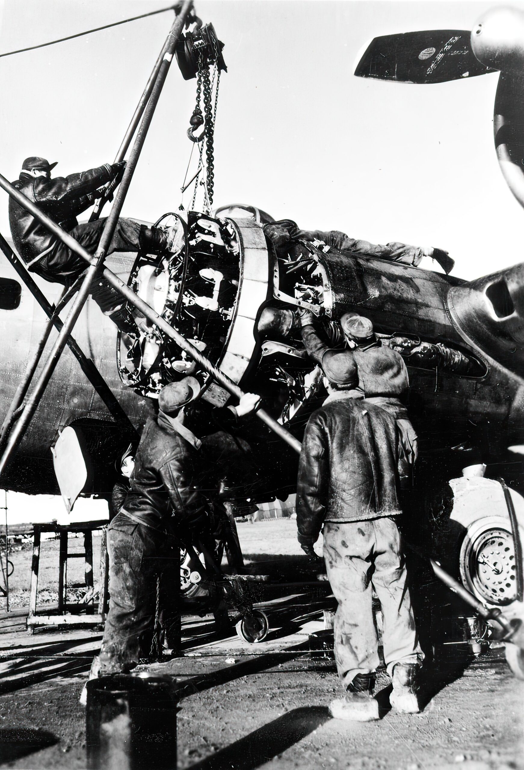 Aircraft mechanics with the 398th Bombardment Group change a B-17 Flying Fortress engine