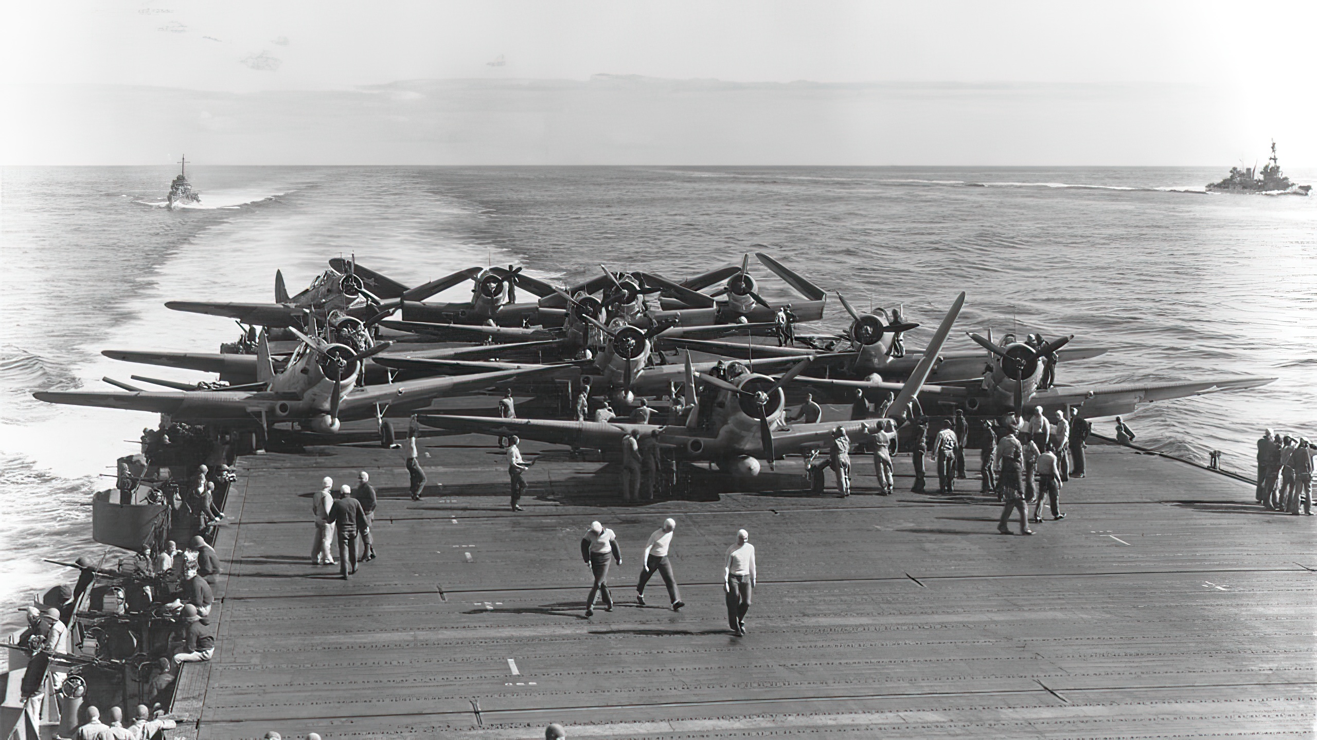 U.S. Navy Torpedo Squadron 6 (VT-6) Douglas TBD-1 Devastator aircraft are prepared for launching aboard the aircraft carrier USS Enterprise (CV-6) at about 0730-0740 hrs, 4 June 1942. Eleven of the fourteen TBDs launched from Enterprise are visible. Three more TBDs and ten Grumman F4F-4 Wildcat fighters must still be pushed into position before launching can begin
