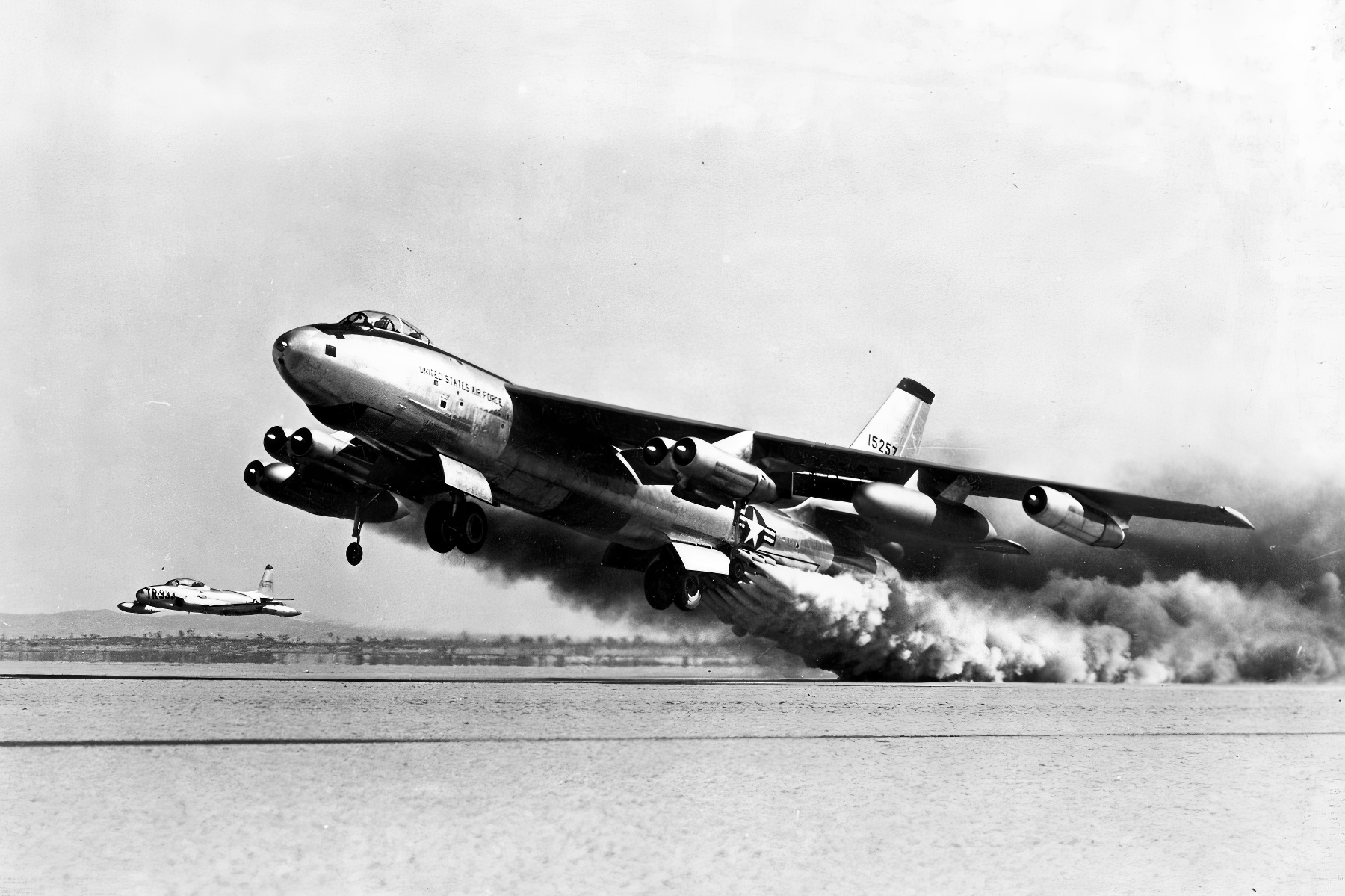 Boeing B-47E-65-BW (S/N 51-5257, o último modelo bloco 65-E construído pela Boeing) durante teste de decolagem assistida por foguete, com um Lockheed F-80 como avião de perseguição